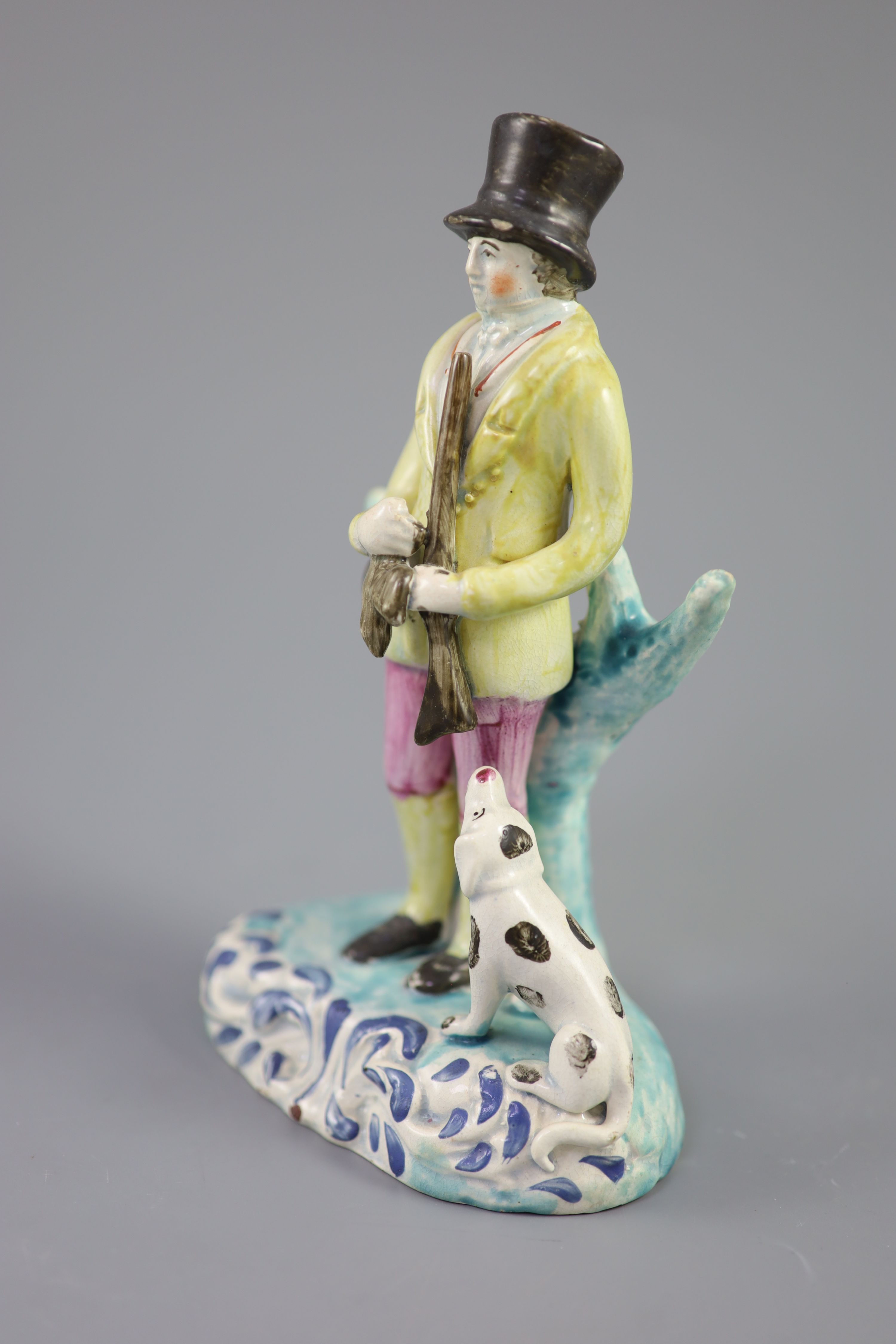 A Staffordshire pearlware group of a huntsman with dog and gun, c.1820-30, 18.5cm high